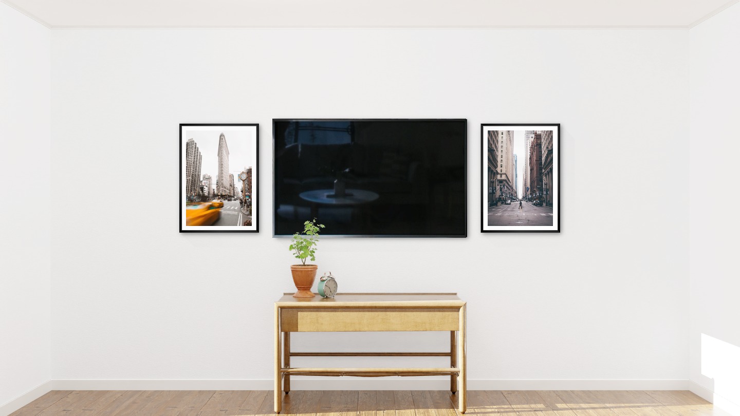 Two black picture frames in the size 50x70 around a TV