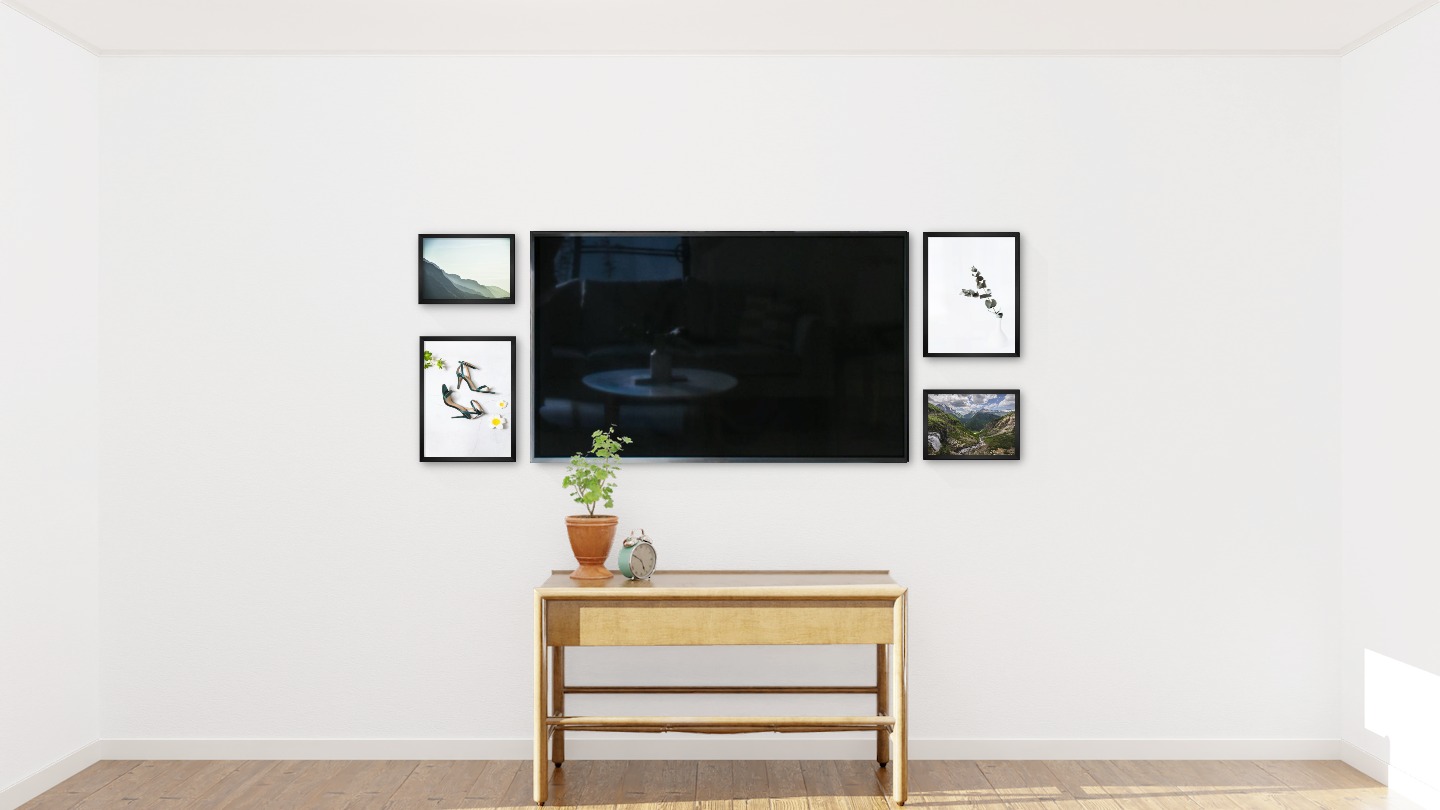Four black picture frames in the sizes 30x40 and 21x30 around a TV