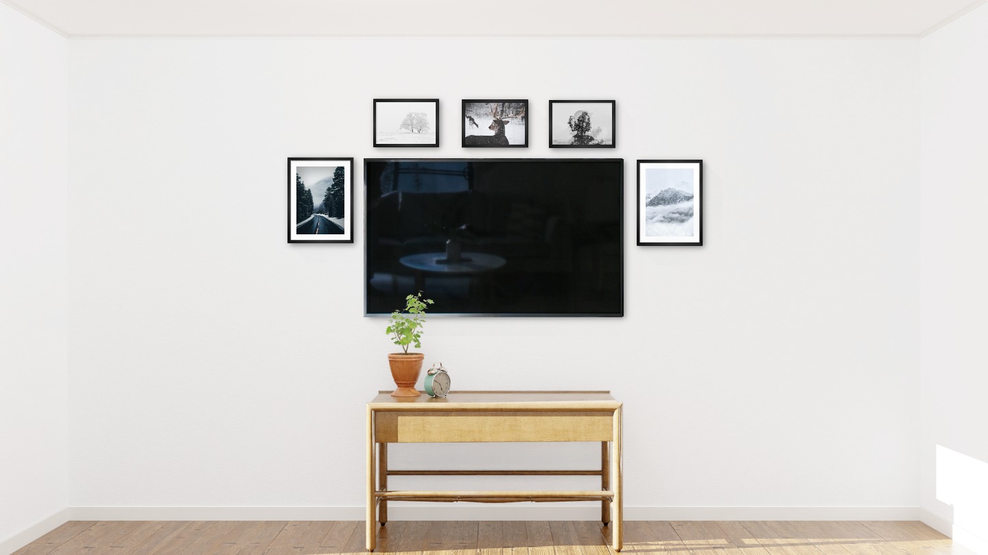 Five black picture frames in the sizes 30x40 and 21x30 around a TV