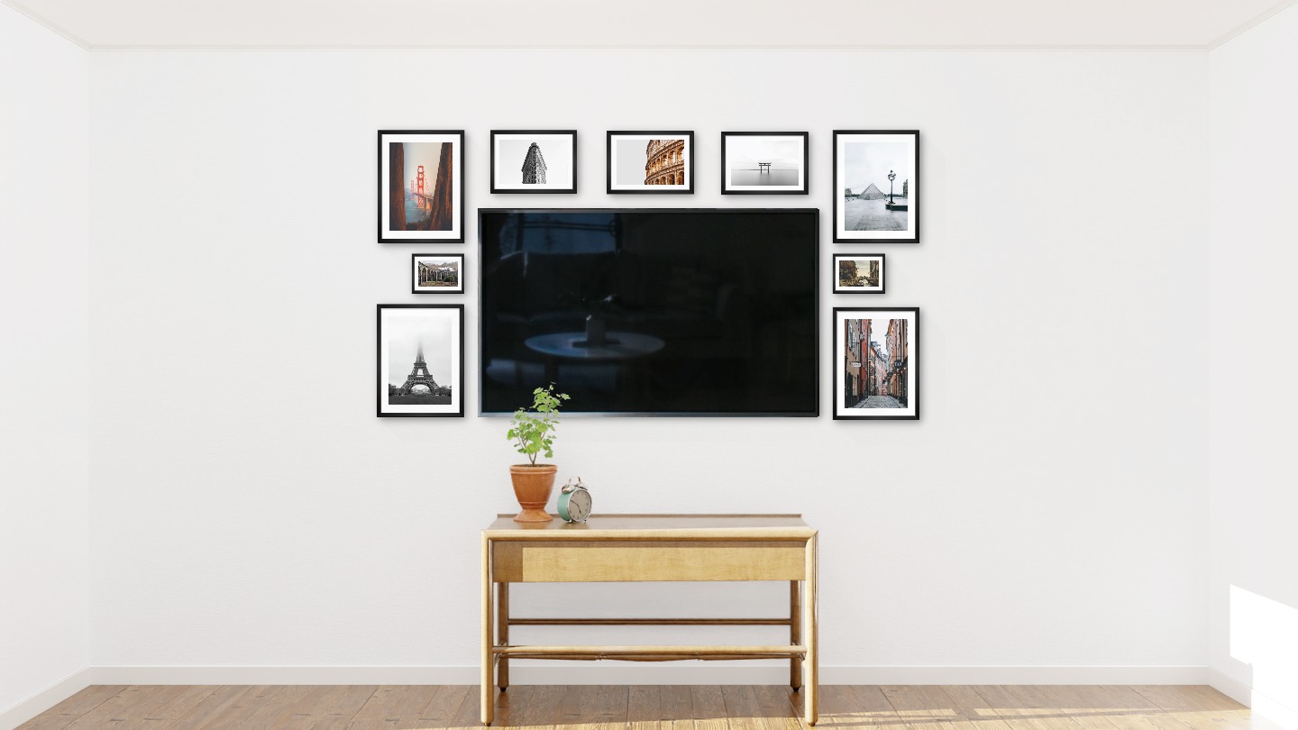 Nine black picture frames in the sizes 30x40, 21x30 and 13x18 around a TV