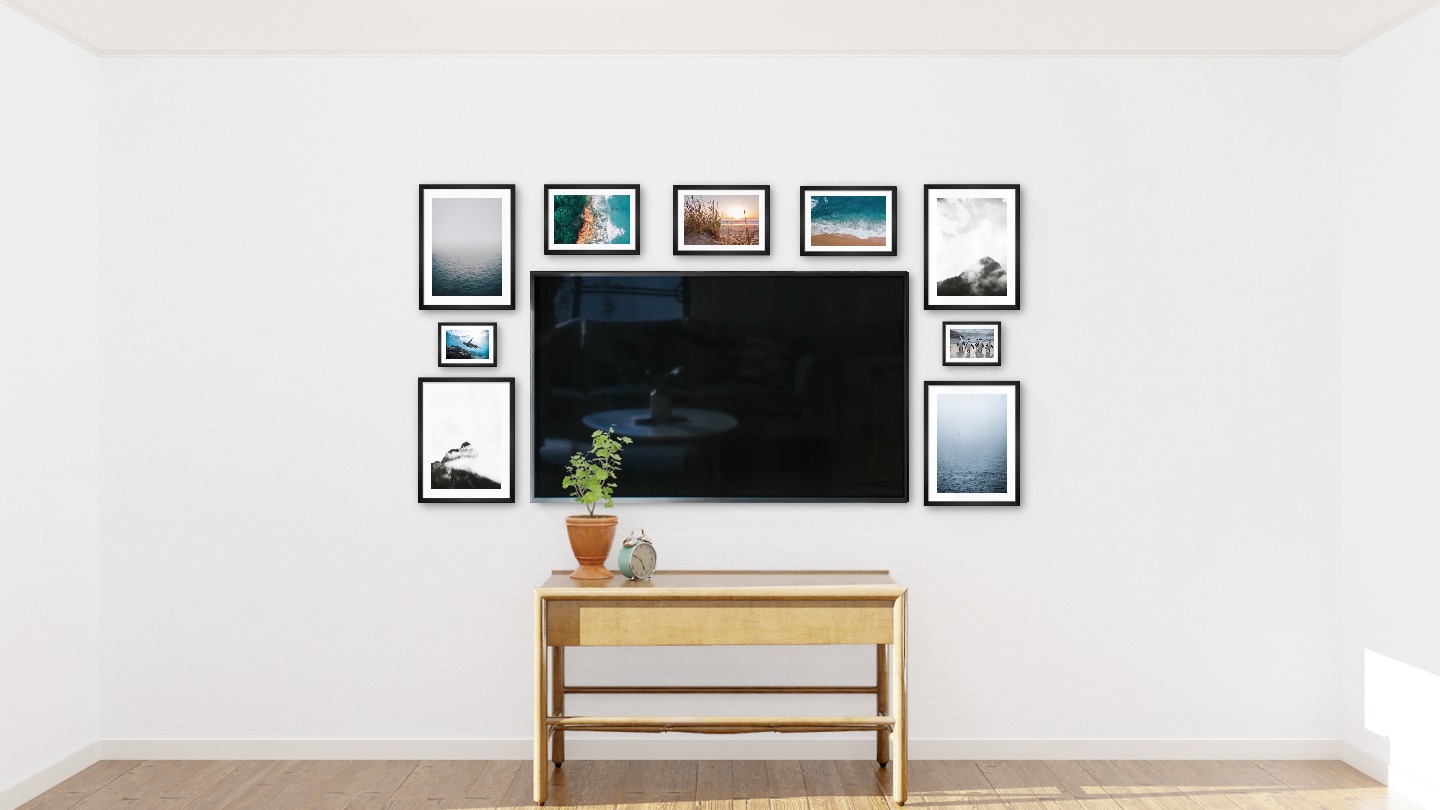 Nine black picture frames in the sizes 30x40, 21x30 and 13x18 around a TV