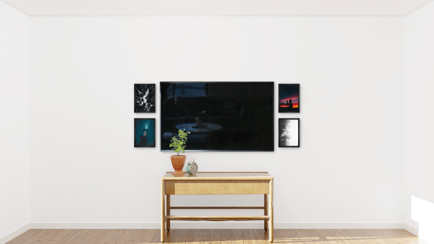 Four black picture frames in the size 21x30 around a TV