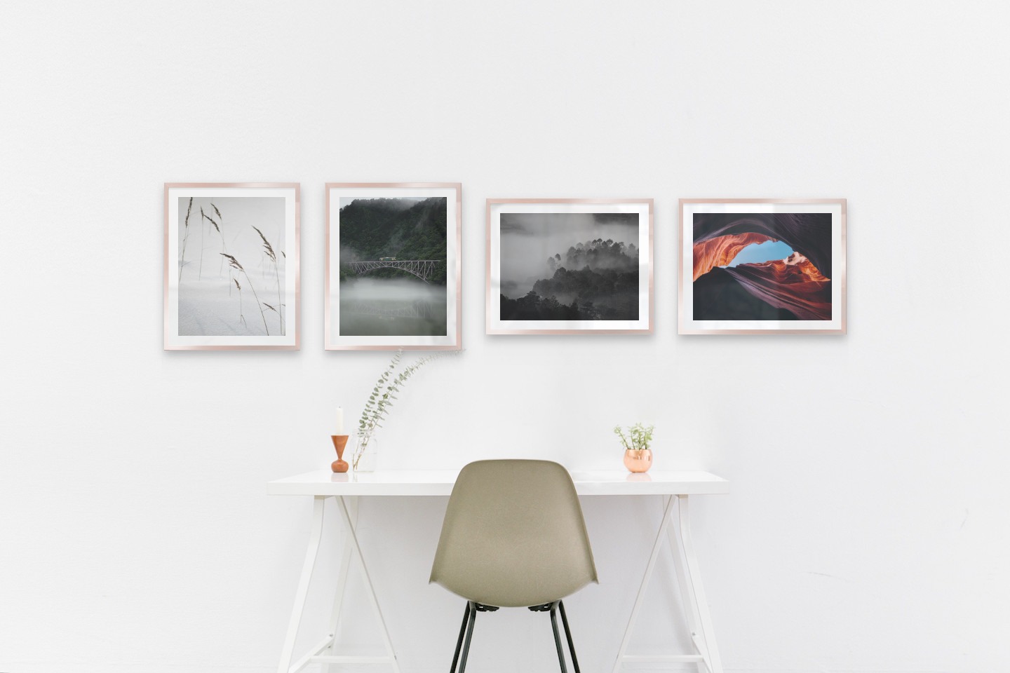 Gallery wall with picture frames in copper in sizes 40x50 with prints "Sharp in the snow", "Train over bridge", "Foggy wooden tops" and "Red rock formations"