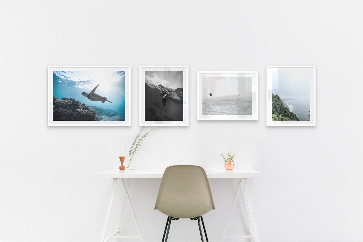 Gallery wall with picture frames in white in sizes 50x70 and 40x50 with prints "Turtle in the water", "Turtle", "Birds over the sea" and "Rocks facing the water"