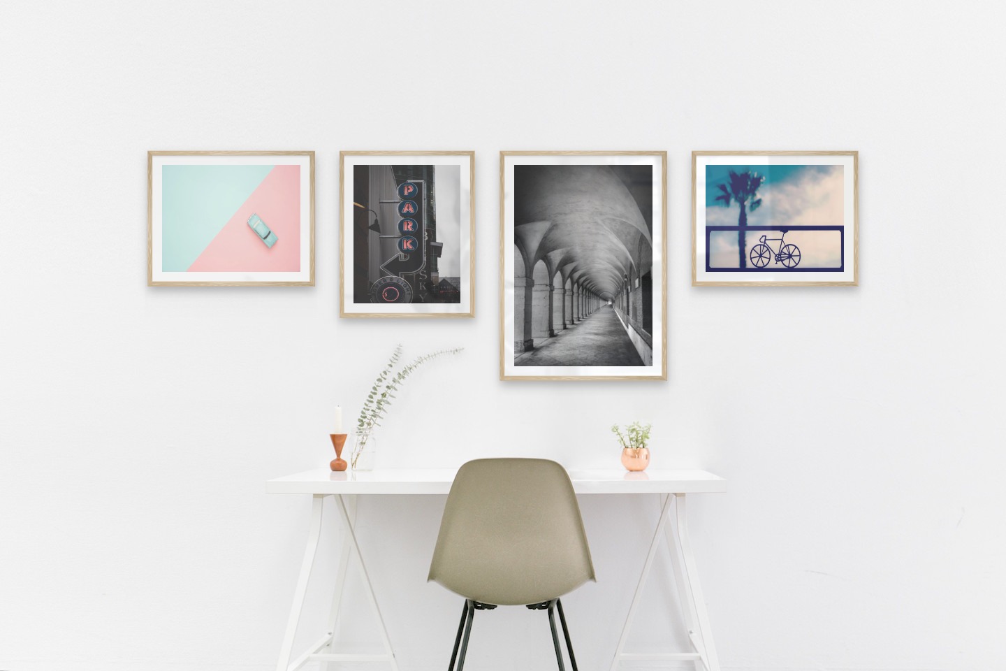 Gallery wall with picture frames in wood in sizes 40x50 and 50x70 with prints "Blue car and pink", "Sign "Park"", "Hallway with pillars and arches" and "Bicycle in front of sky"