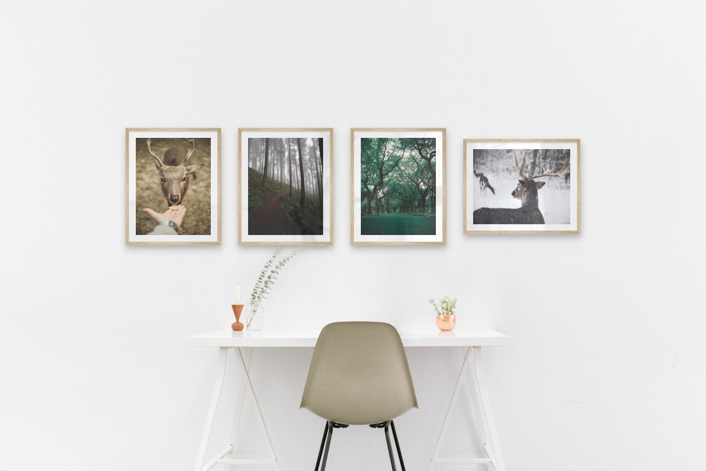Gallery wall with picture frames in wood in sizes 40x50 with prints "Feed a deer", "Forest road", "Greenery and trees" and "Deer in the snow"