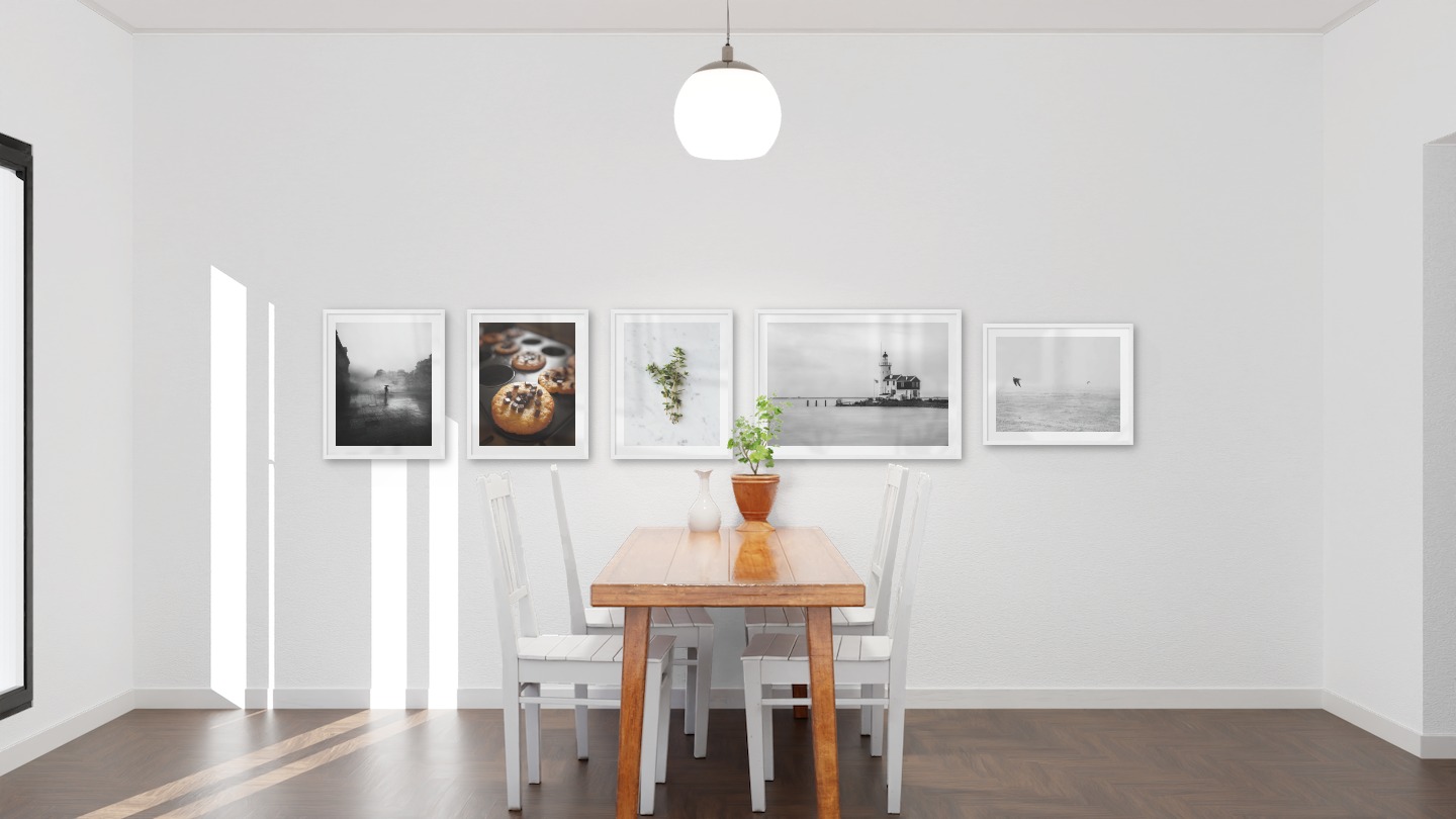 Gallery wall with picture frames in white in sizes 40x50 and 50x70 with prints "Rainy city", "Cookies with chocolate", "Herbs", "Pier with building" and "Birds over the sea"