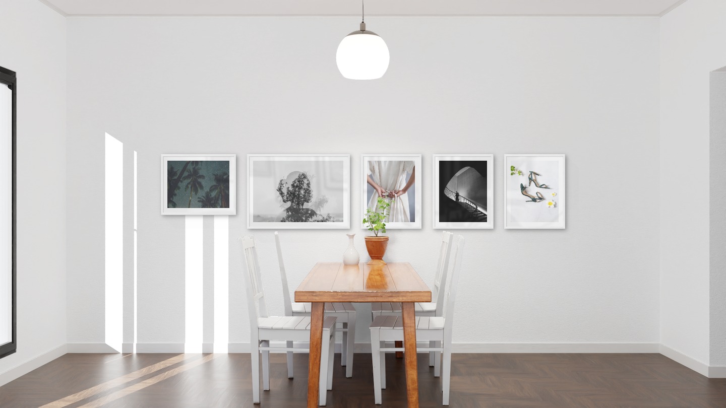 Gallery wall with picture frames in white in sizes 40x50 and 50x70 with prints "Palm trees and night sky", "Trees and silhouette", "Dress with waistband", "Staircase" and "Heels"