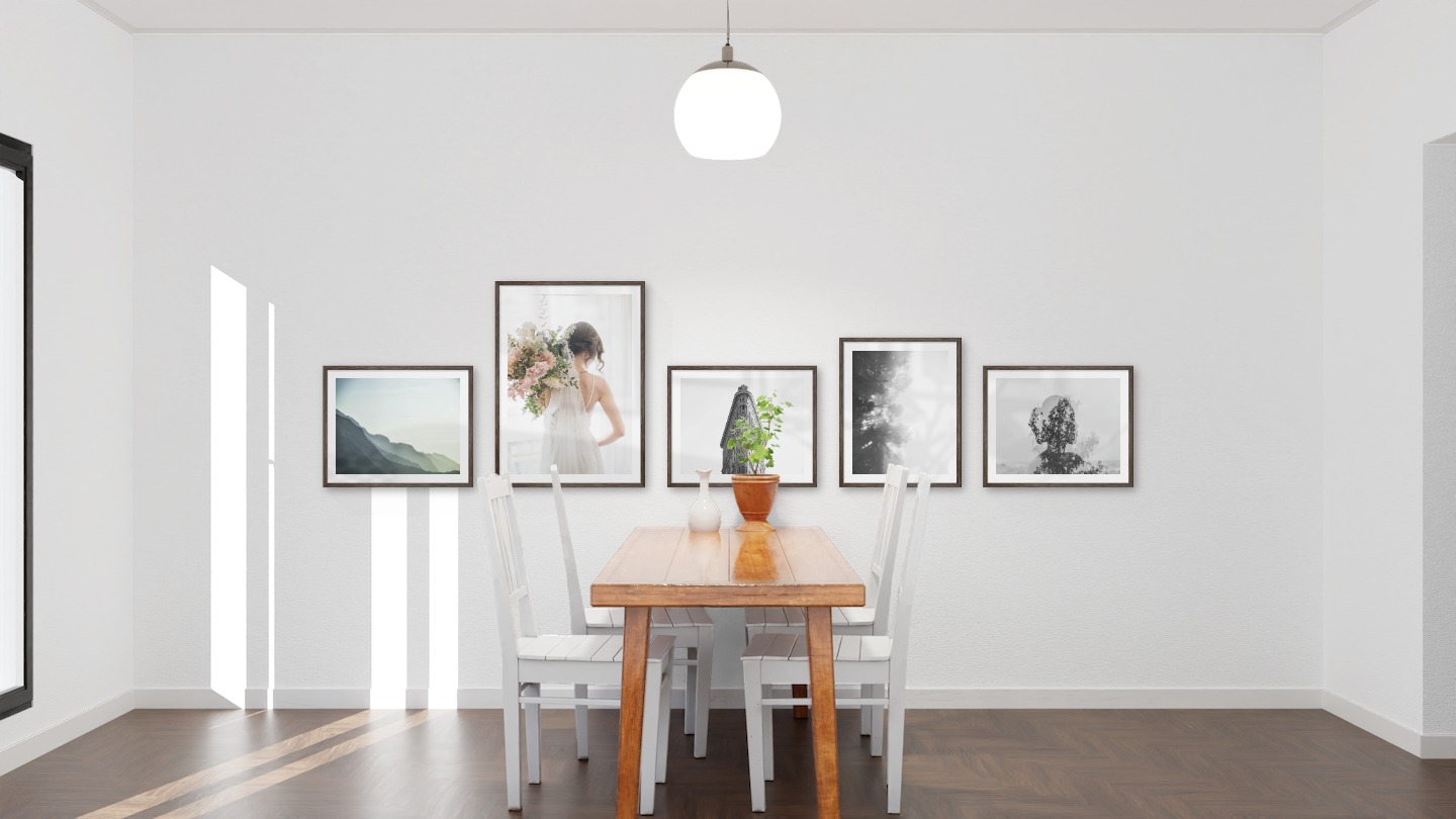 Gallery wall with picture frames in dark wood in sizes 40x50 and 50x70 with prints "Foggy mountain", "Bride and flowers", "Triangular building", "Foggy wooden tops from the side" and "Trees and silhouette"