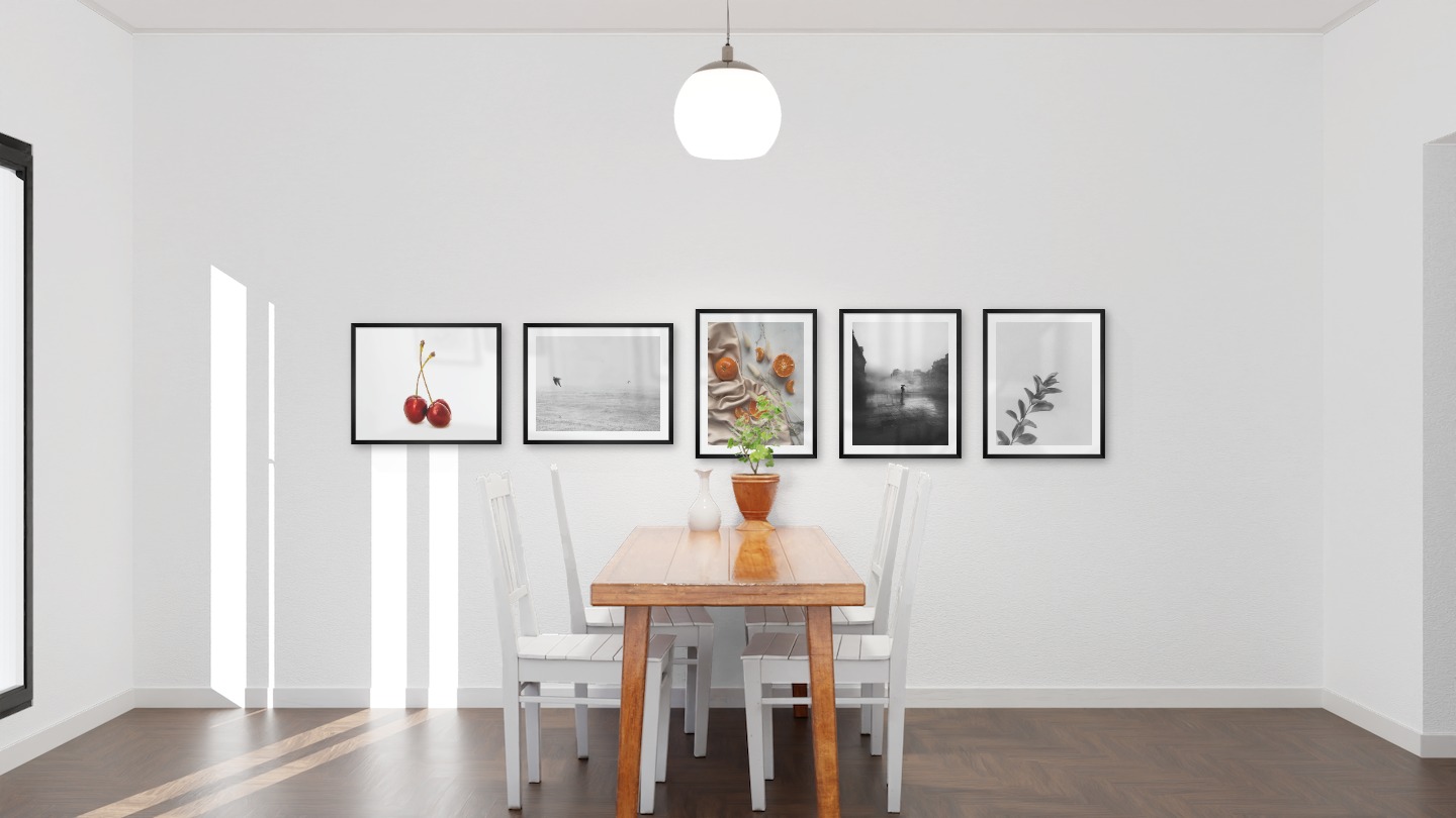 Gallery wall with picture frames in black in sizes 40x50 with prints "Cherries with white background", "Birds over the sea", "Oranges", "Rainy city" and "Twig"