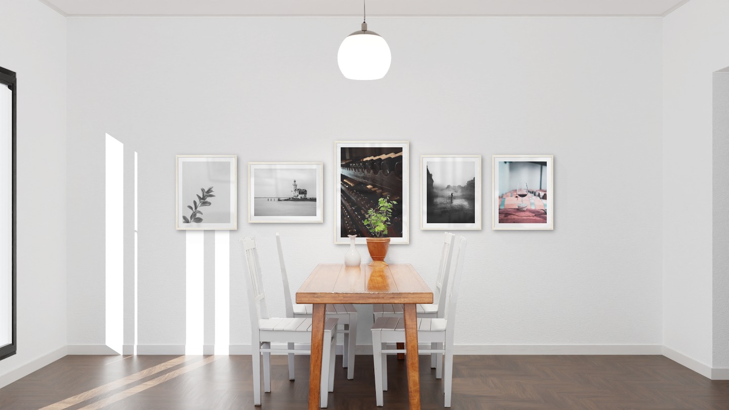 Gallery wall with picture frames in light wood in sizes 40x50 and 50x70 with prints "Twig", "Pier with building", "Wine storage", "Rainy city" and "Wine glasses in barrels"