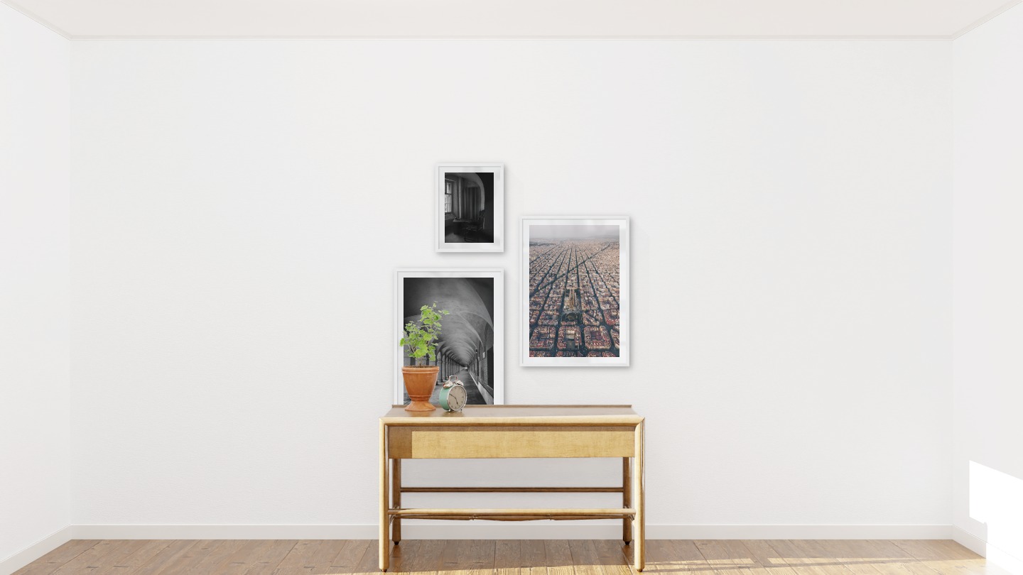 Gallery wall with picture frames in white in sizes 30x40 and 50x70 with prints "Chair in front of window", "Hallway with pillars and arches" and "Barcelona city center"