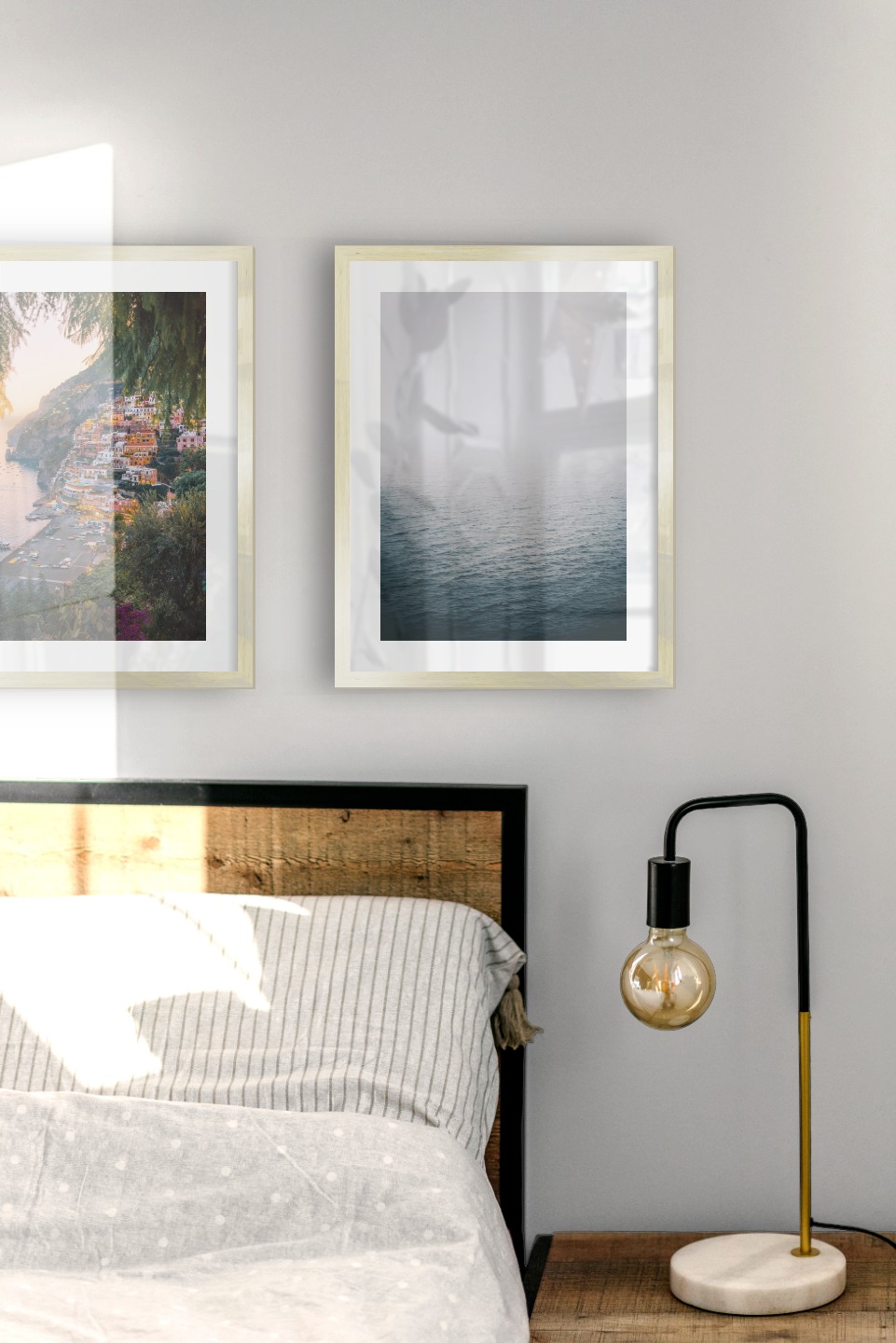 Gallery wall with picture frames in gold in sizes 30x40 with prints "City by the sea" and "Fog over the sea"