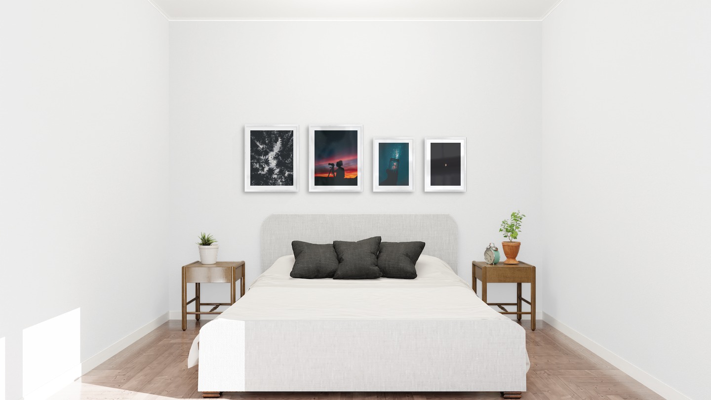 Gallery wall with picture frames in silver in sizes 40x50 and 30x40 with prints "Wooden tops and birds", "Photographer at night", "Jar in front of space" and "The moon"