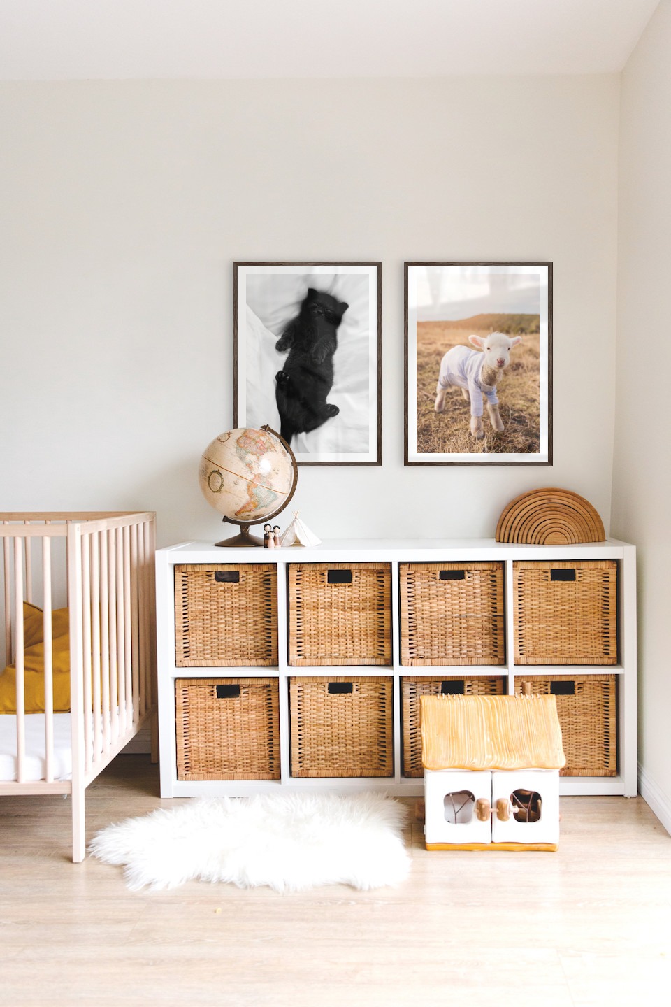 Gallery wall with picture frames in dark wood in sizes 50x70 with prints "Cat in bed" and "Lamb"