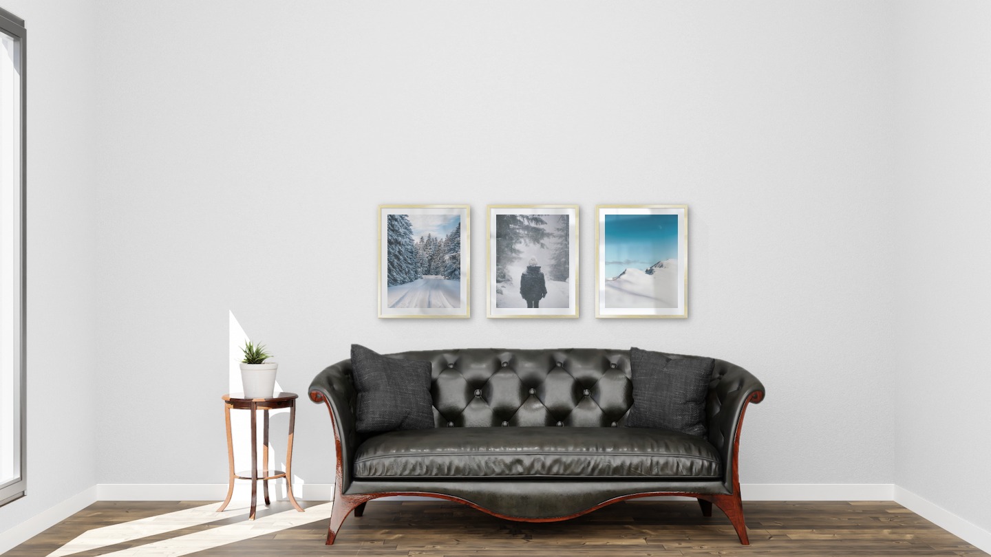 Gallery wall with picture frames in gold in sizes 40x50 with prints "Snowy road", "Person in the snow" and "Snowy mountain peaks"