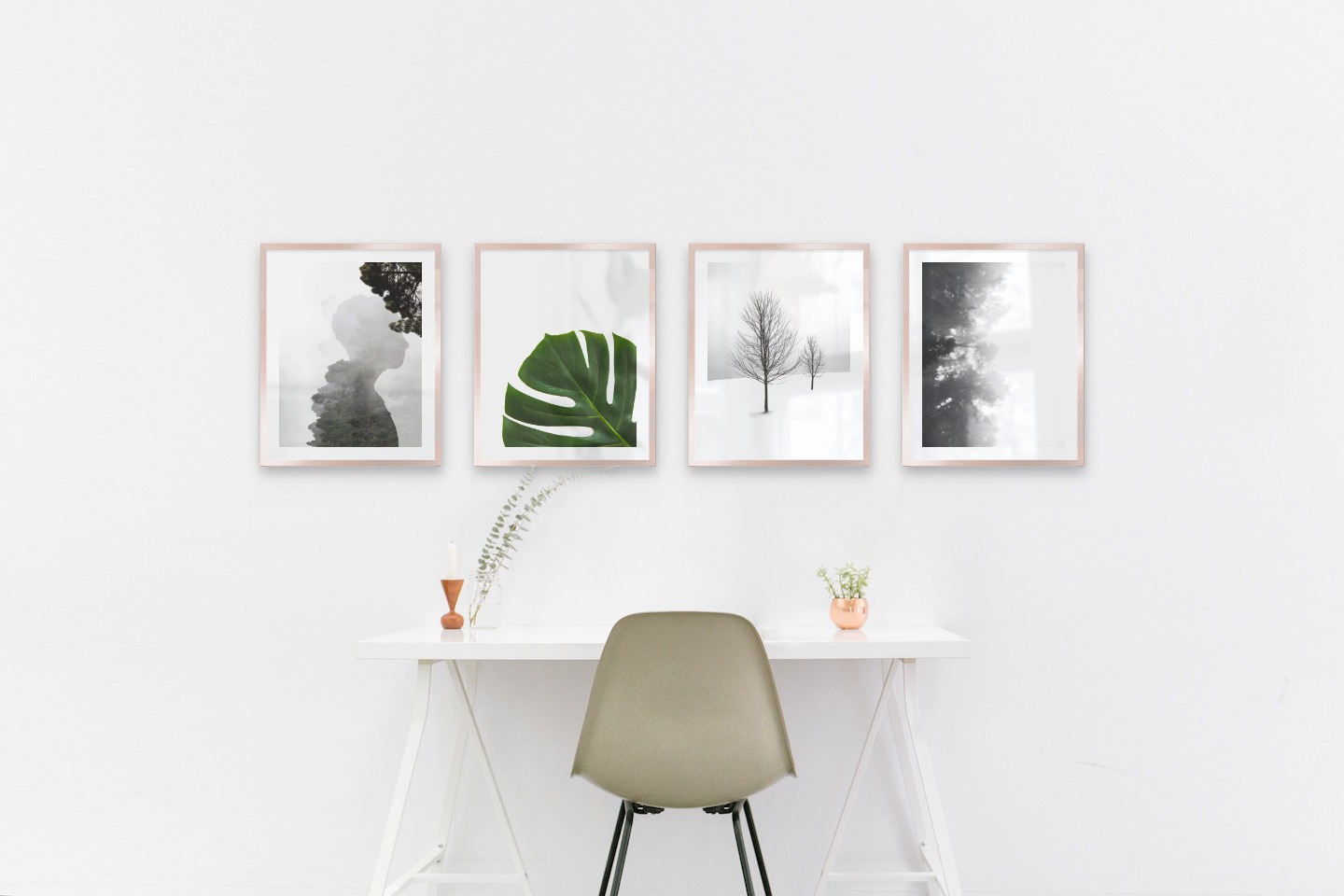 Gallery wall with picture frames in copper in sizes 40x50 with prints "Silhouette and tree", "Plant", "Trees in the snow" and "Foggy wooden tops from the side"