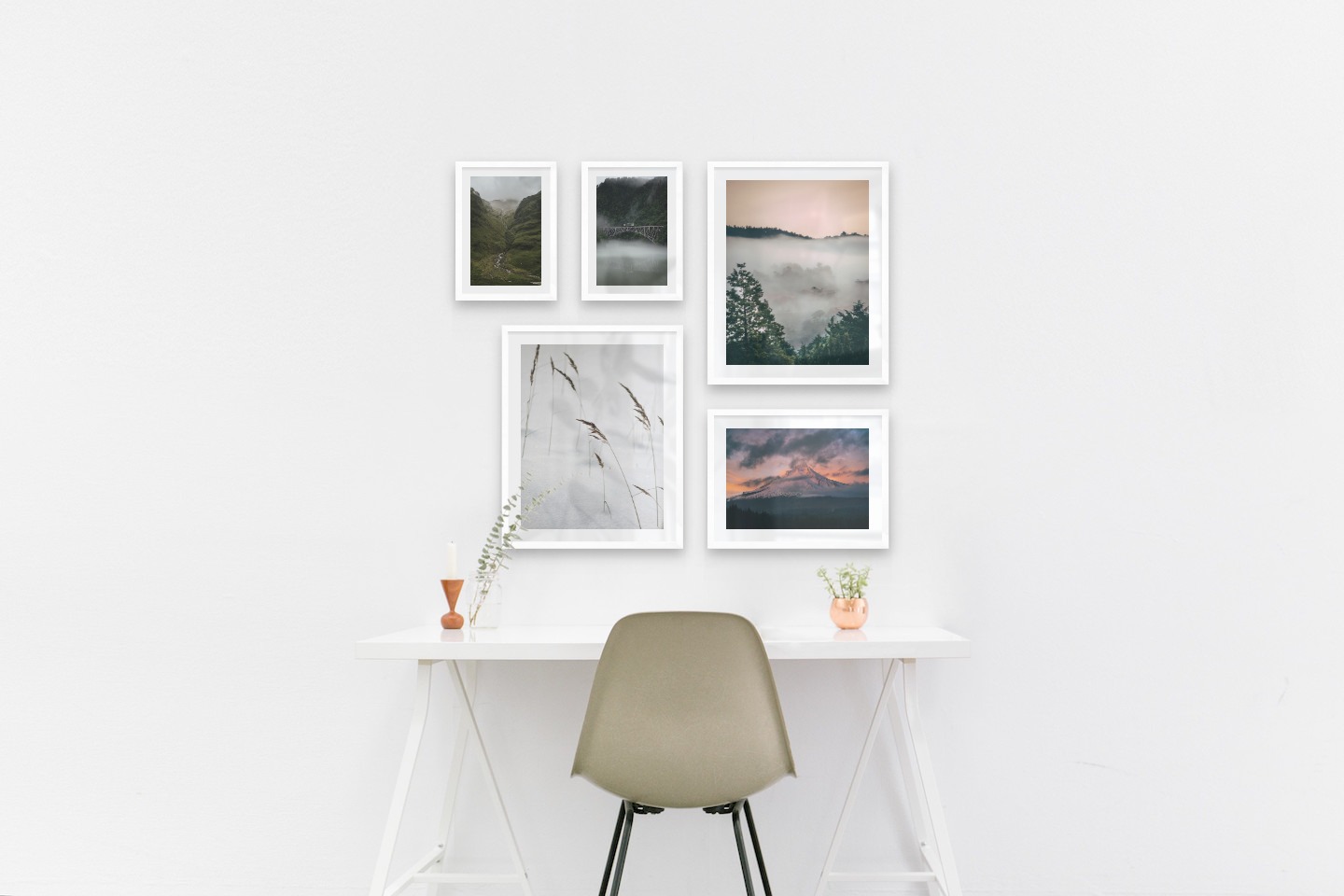 Gallery wall with picture frames in white in sizes 21x30, 40x50 and 30x40 with prints "Train over bridge", "Stream in valley", "Sharp in the snow", "Wooden tops and orange sky" and "Sunset and mountains"