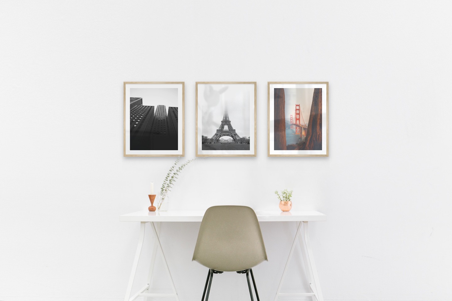 Gallery wall with picture frames in wood in sizes 40x50 with prints "High buildings", "Eifel tower with fog" and "Golden Gate Bridge"