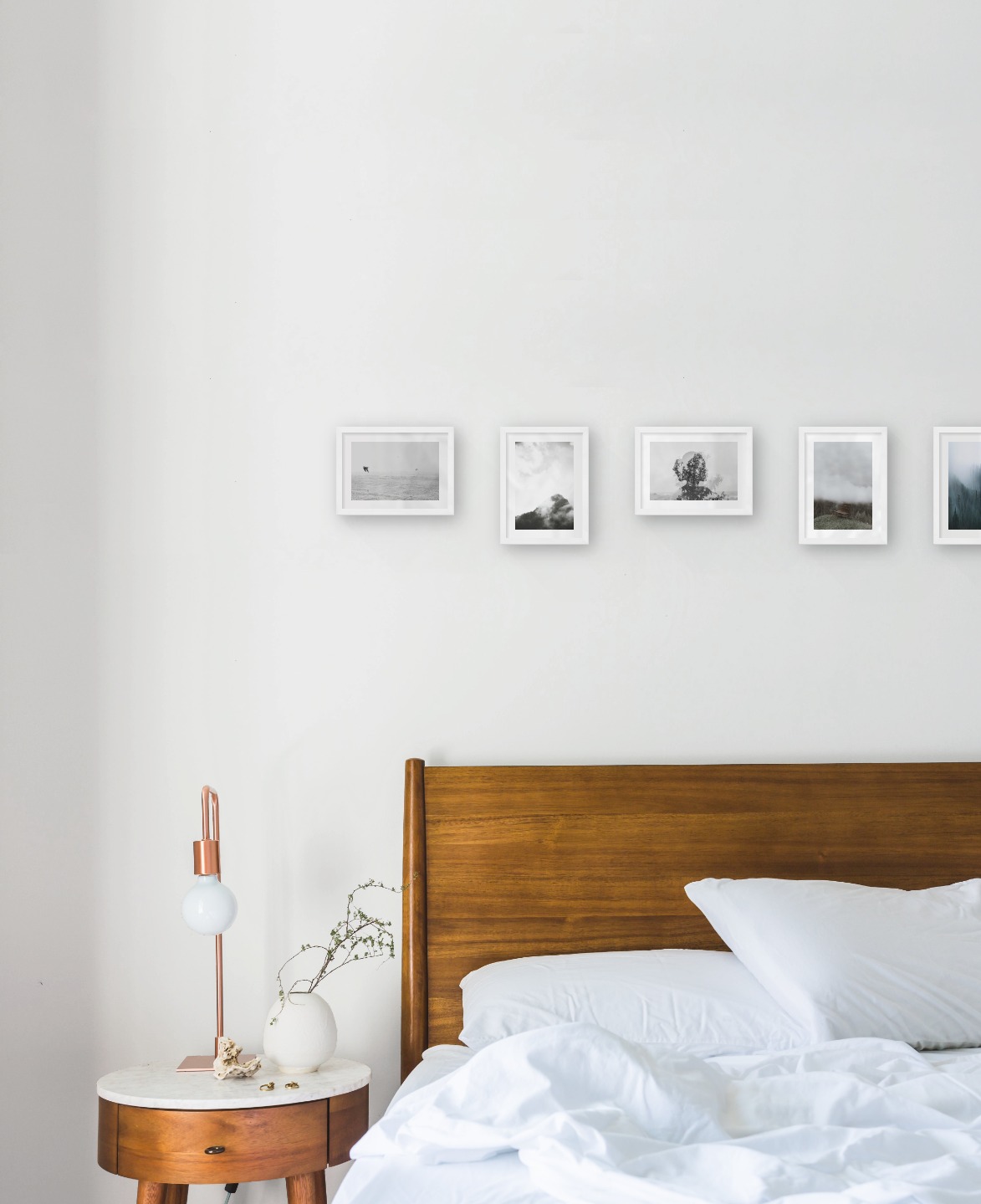 Gallery wall with picture frames in white in sizes 13x18 with prints "Birds over the sea", "Trees and mountains in fog", "Trees and silhouette", "Bench in misty nature" and "Foggy forest"