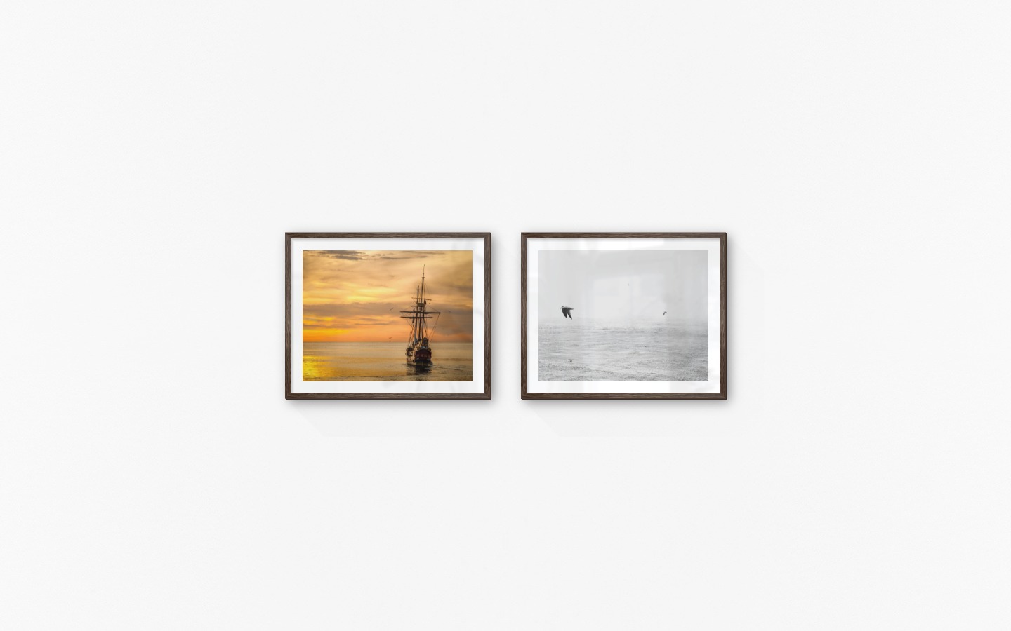 Gallery wall with picture frames in dark wood in sizes 40x50 with prints "Ships at sea" and "Birds over the sea"