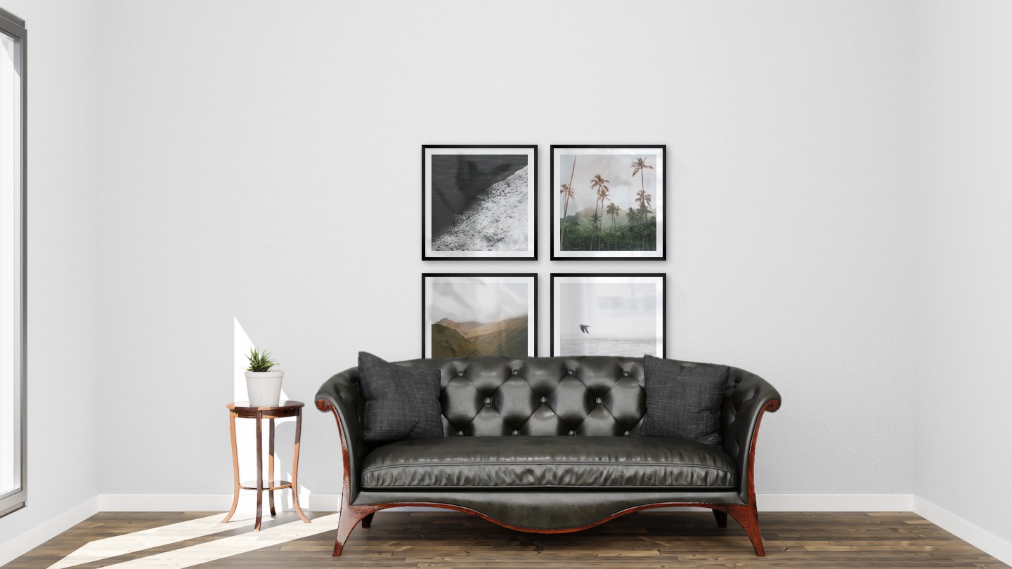 Gallery wall with picture frames in black in sizes 50x50 with prints "Swell from waves", "Palm trees and mountains", "Foggy valley" and "Birds over the sea"