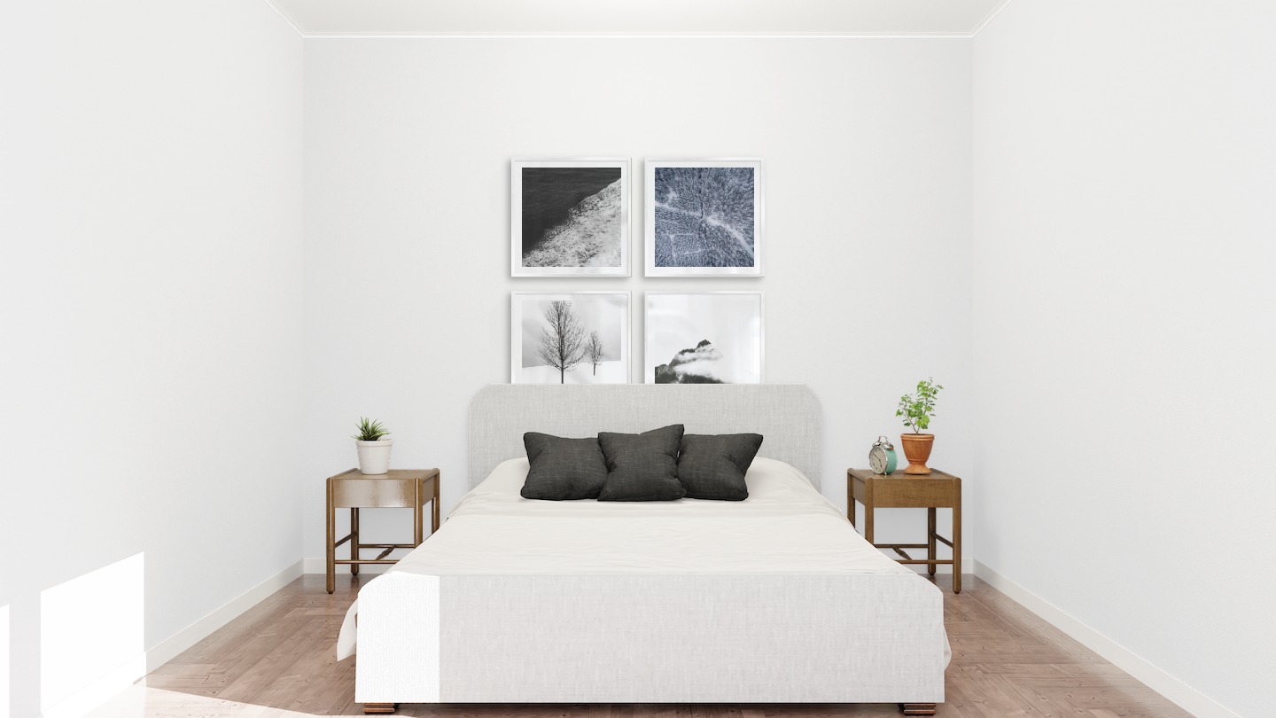 Gallery wall with picture frames in silver in sizes 50x50 with prints "Swell from waves", "Snowy treetops", "Trees in the snow" and "Mountain peaks in fog"
