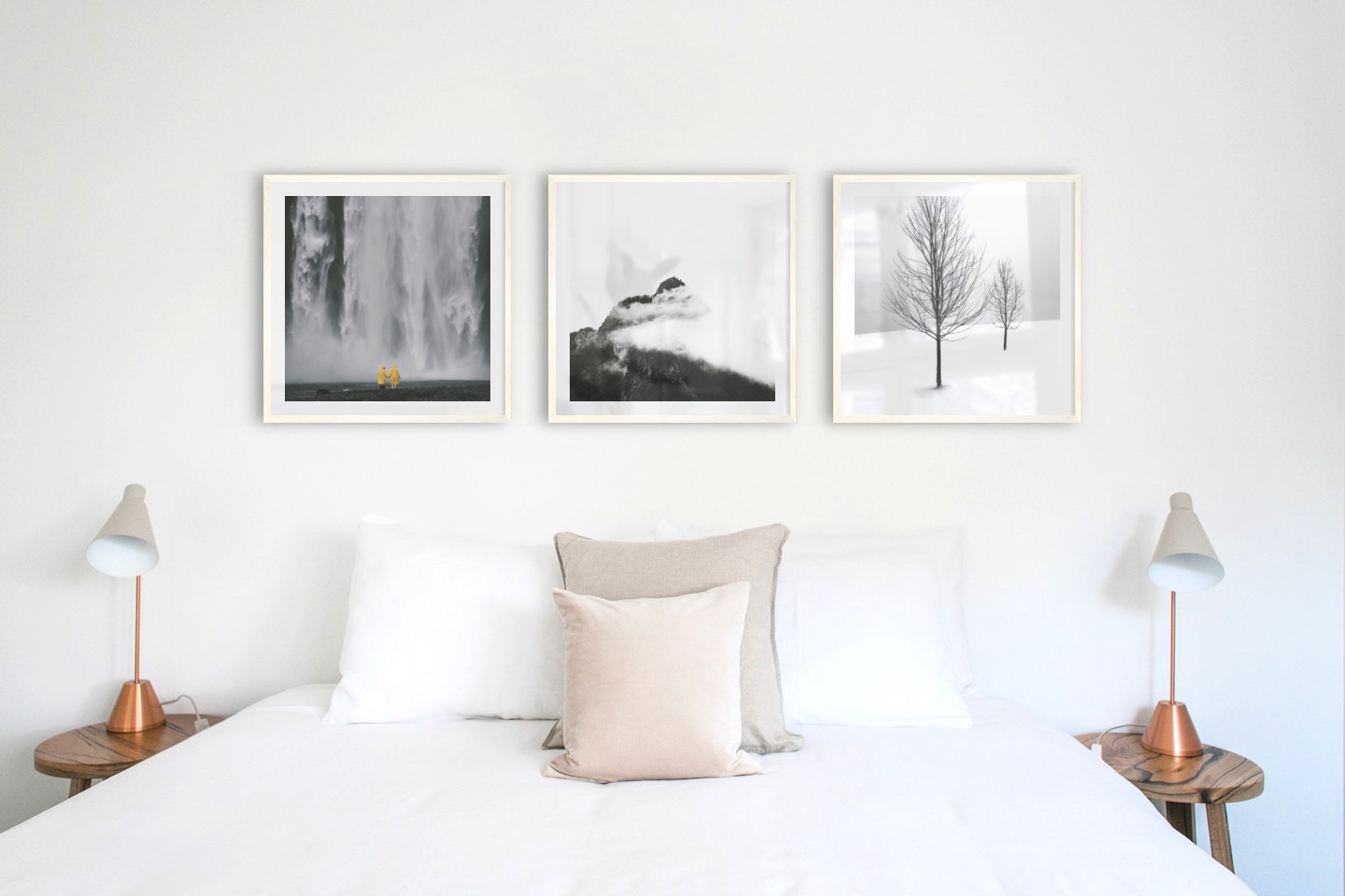 Gallery wall with picture frames in light wood in sizes 50x50 with prints "Waterfall with people", "Mountain peaks in fog" and "Trees in the snow"