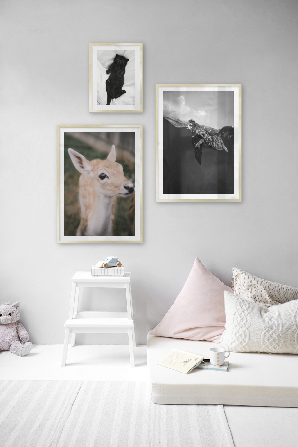 Gallery wall with picture frames in gold in sizes 30x40 and 50x70 with prints "Cat in bed", "Deer" and "Turtle"