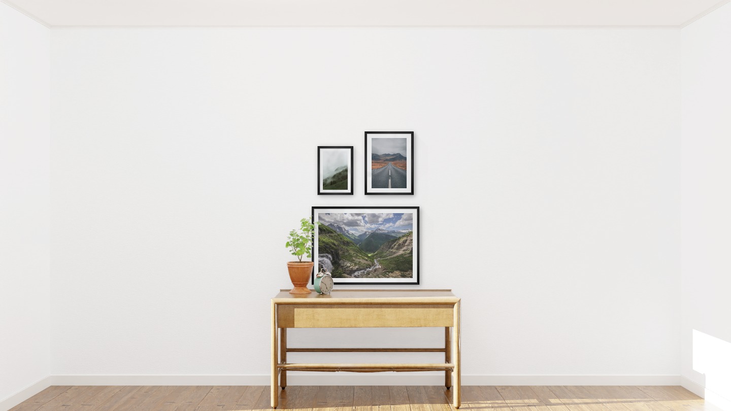 Gallery wall with picture frames in black in sizes 21x30, 30x40 and 50x70 with prints "Foggy slope", "Road and mountains" and "Bergsdal"
