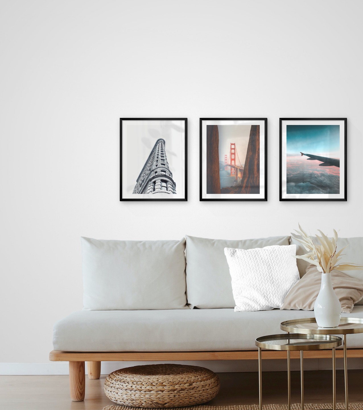 Gallery wall with picture frames in black in sizes 40x50 with prints "Gray building", "Golden Gate Bridge" and "Above the clouds"