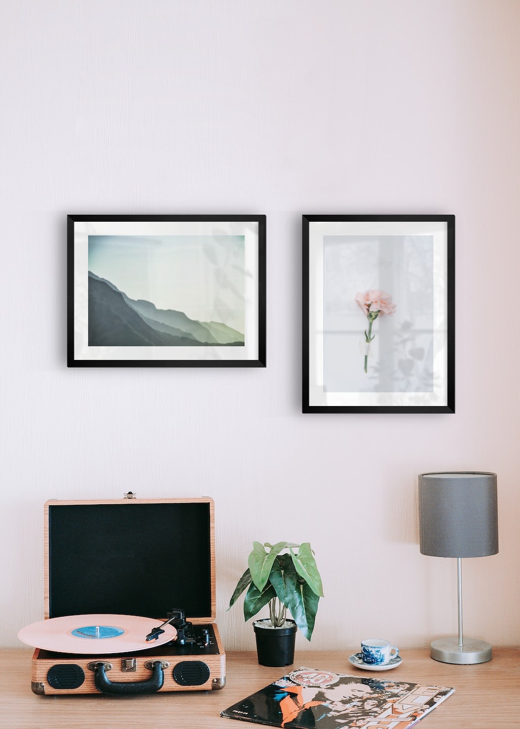 Gallery wall with picture frames in black in sizes 30x40 with prints "Foggy mountain" and "Pink flower"