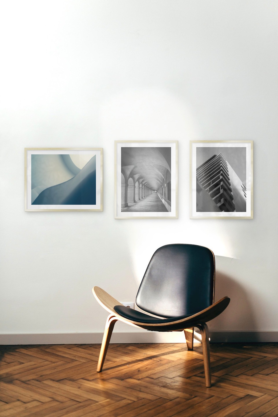 Gallery wall with picture frames in gold in sizes 40x50 with prints "Blue geometry", "Hallway with pillars and arches" and "Black and white building"