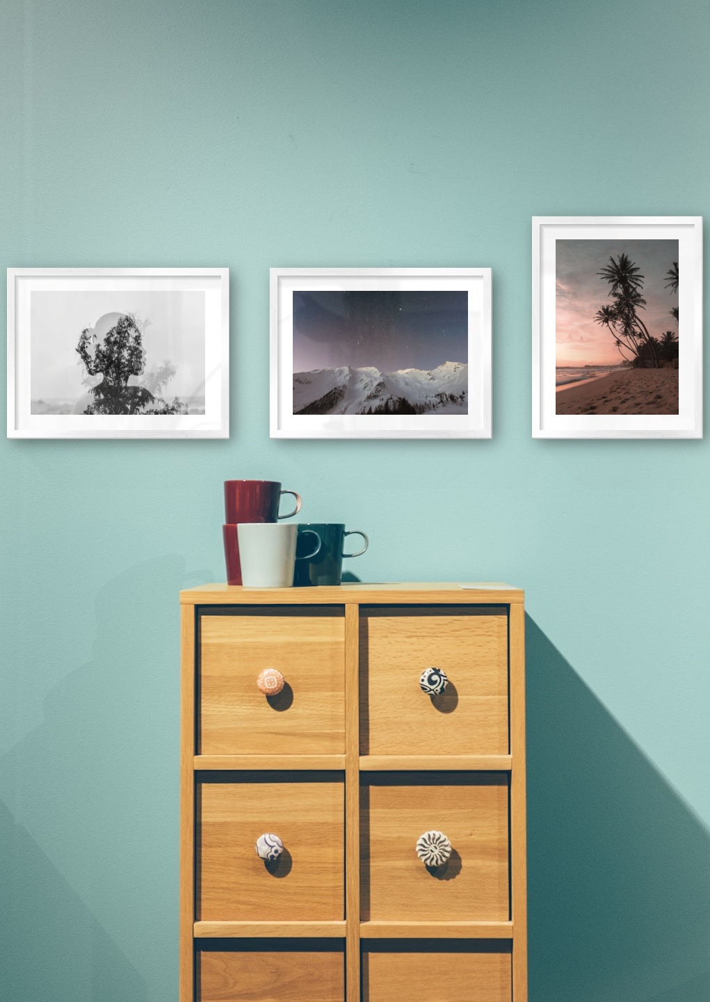 Gallery wall with picture frames in silver in sizes 30x40 with prints "Trees and silhouette", "Mountains with night sky" and "Beach at sunset"