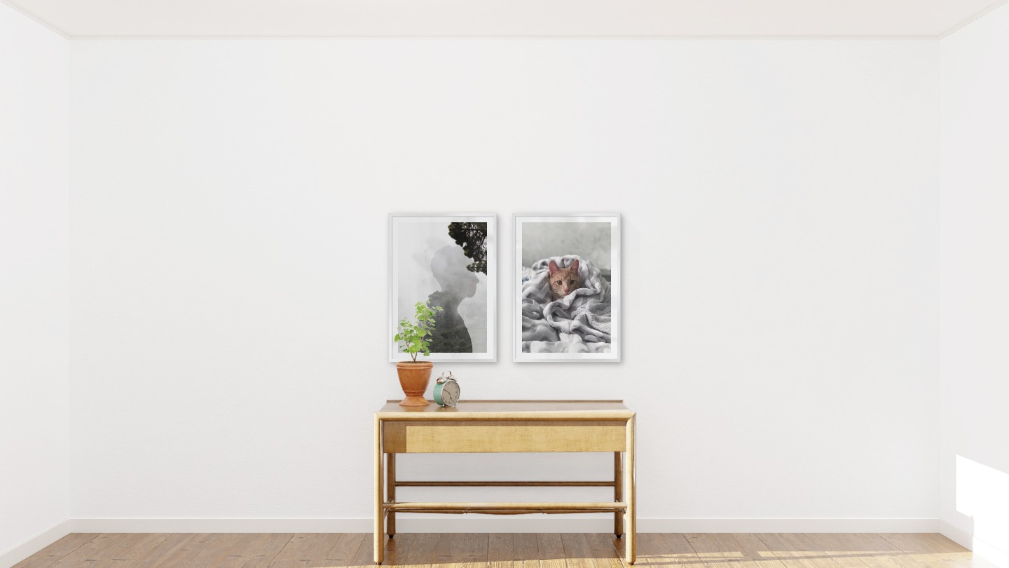 Gallery wall with picture frames in silver in sizes 50x70 with prints "Silhouette and tree" and "Cat in felt"