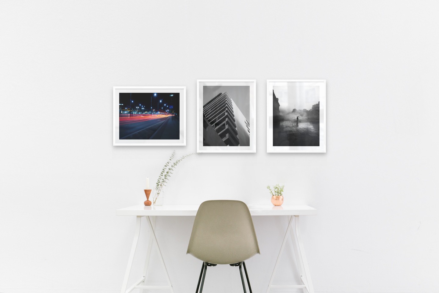 Gallery wall with picture frames in white in sizes 40x50 with prints "Light on the way", "Black and white building" and "Rainy city"