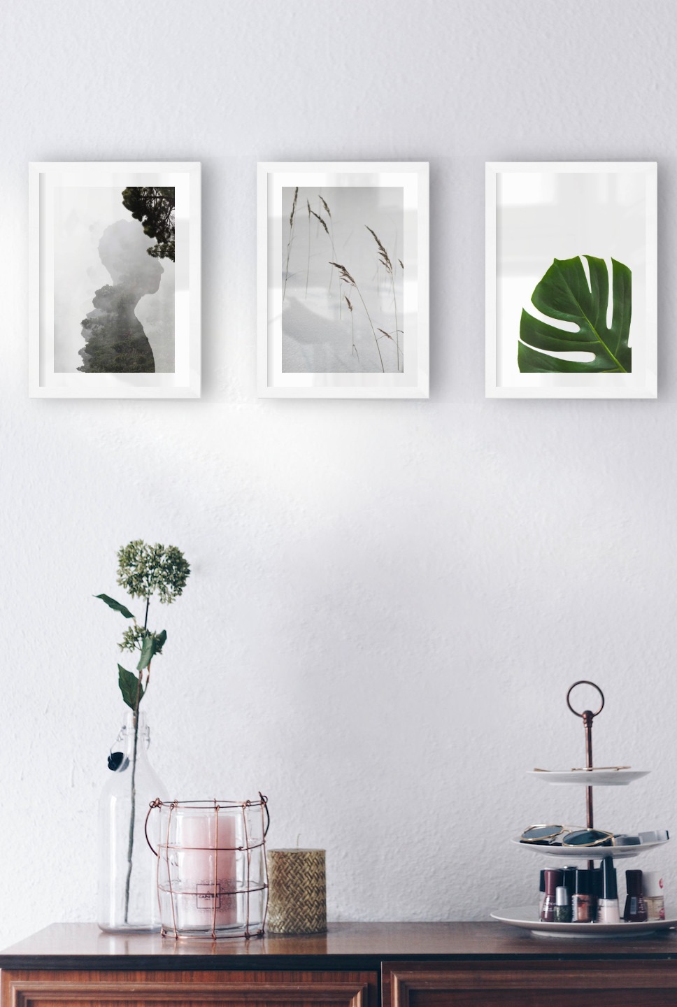 Gallery wall with picture frames in white in sizes 21x30 with prints "Silhouette and tree", "Sharp in the snow" and "Plant"