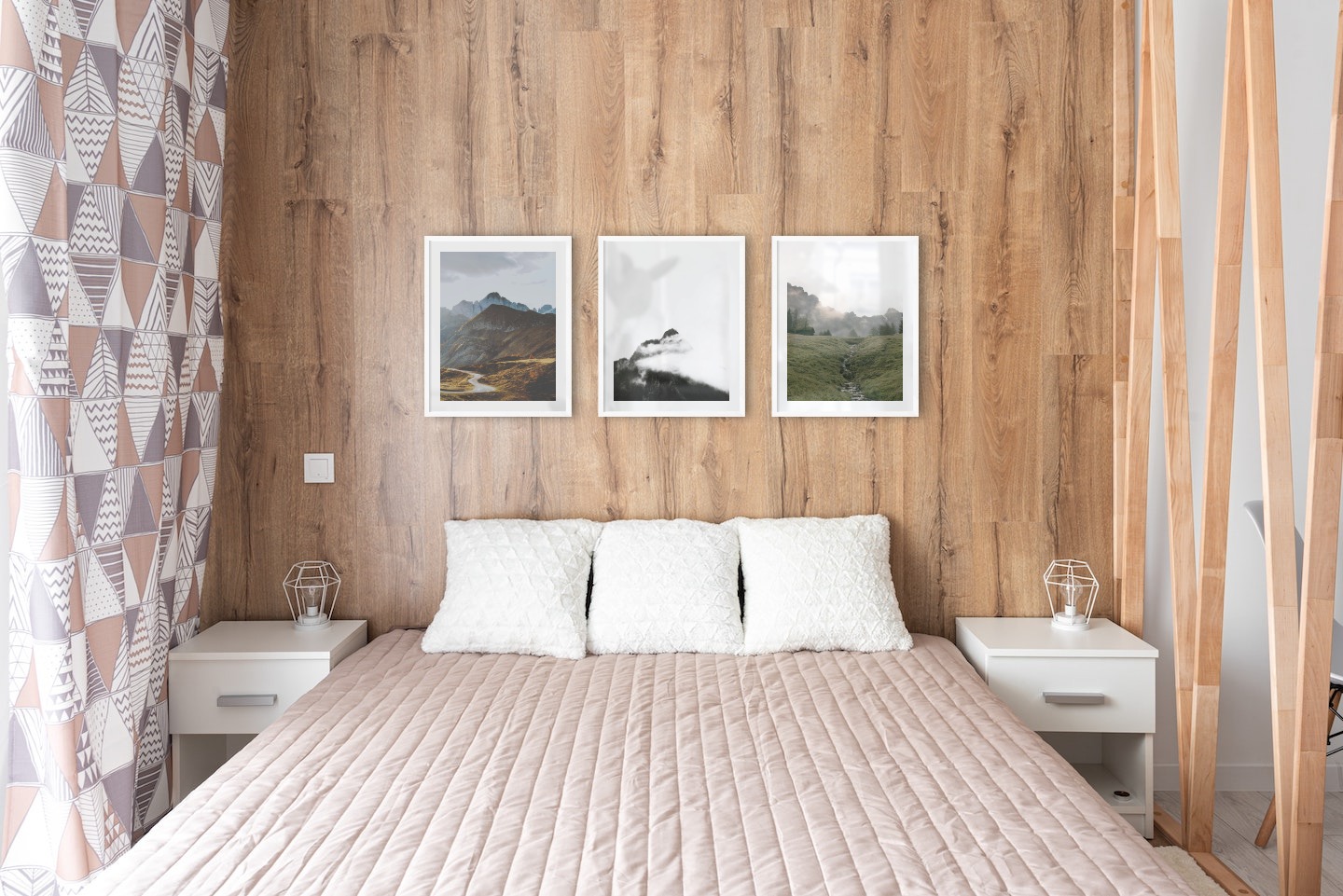 Gallery wall with picture frames in white in sizes 40x50 with prints "Road among the mountains", "Mountain peaks in fog" and "Green valley in front of mountains"