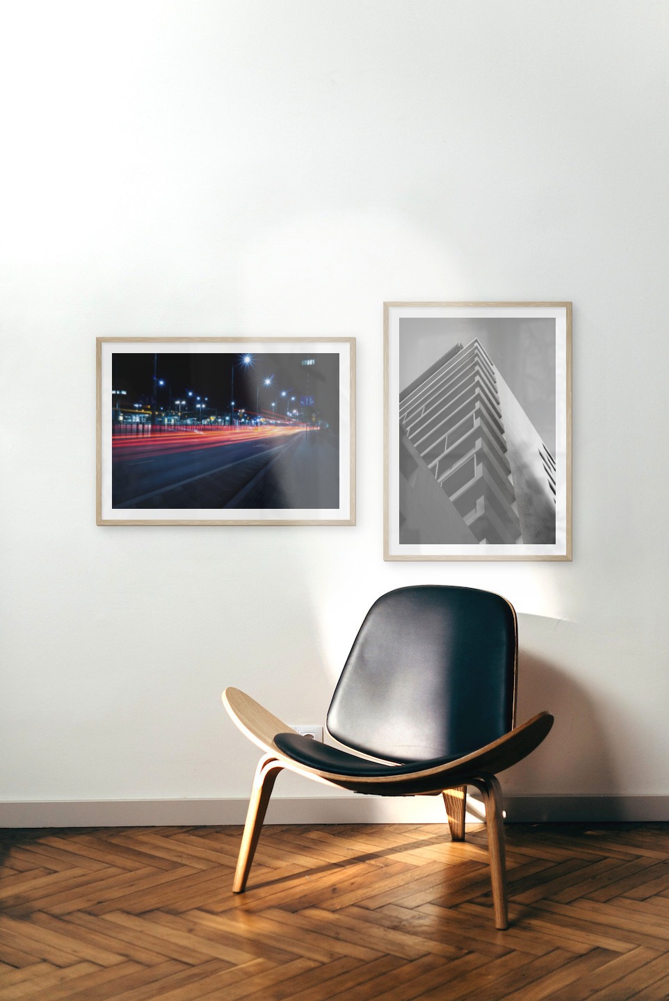 Gallery wall with picture frames in wood in sizes 50x70 with prints "Light on the way" and "Black and white building"