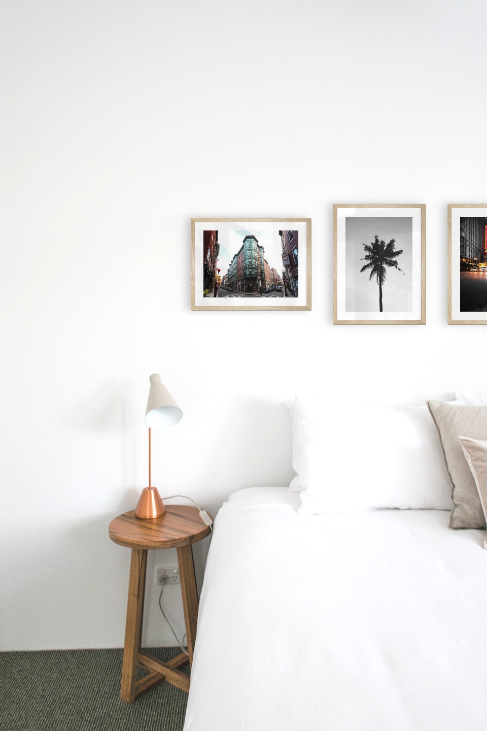 Gallery wall with picture frames in wood in sizes 30x40 with prints "Street corner", "Palm" and "Busy city center"