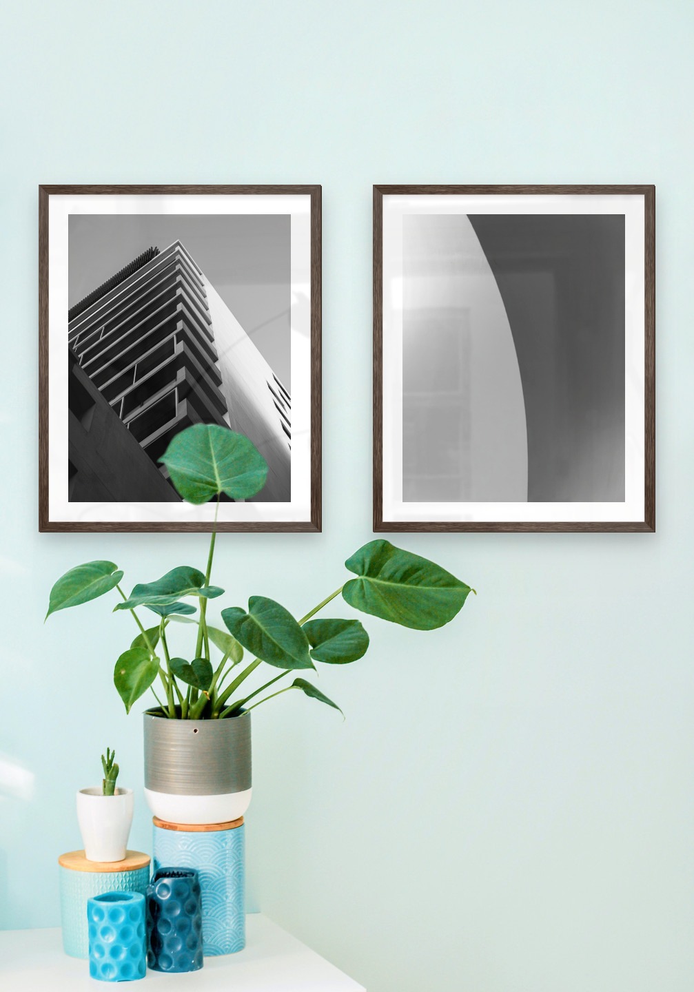 Gallery wall with picture frames in dark wood in sizes 40x50 with prints "Black and white building" and "Line"