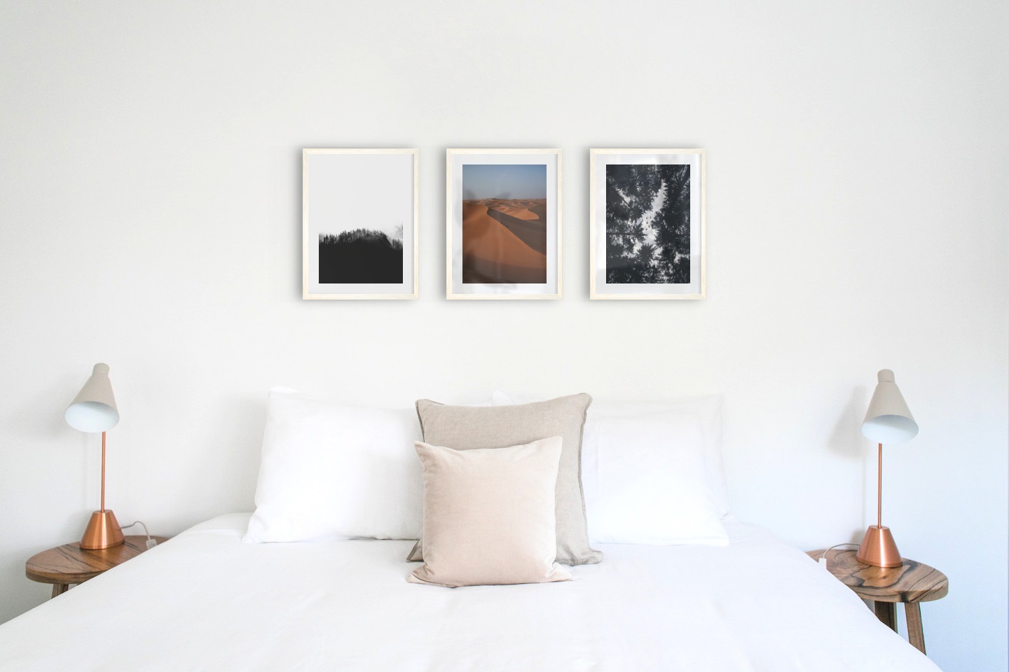 Gallery wall with picture frames in light wood in sizes 30x40 with prints "Wooden tops and fog", "Desert" and "Wooden tops and birds"