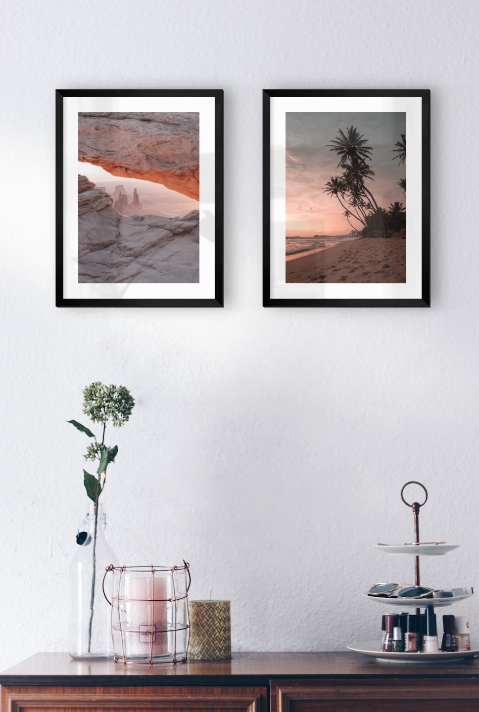 Gallery wall with picture frames in black in sizes 30x40 with prints "View between cliffs" and "Beach at sunset"