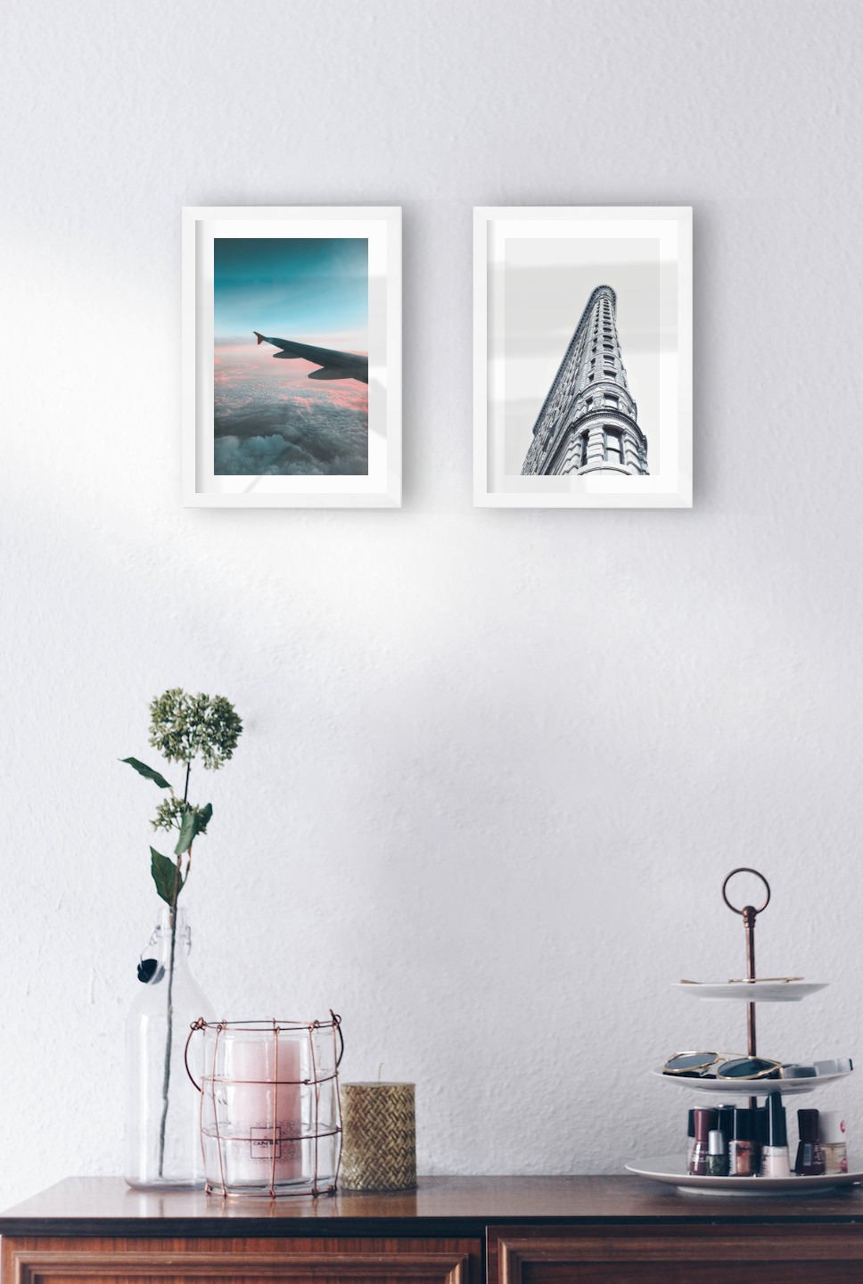Gallery wall with picture frames in white in sizes 21x30 with prints "Above the clouds" and "Gray building"