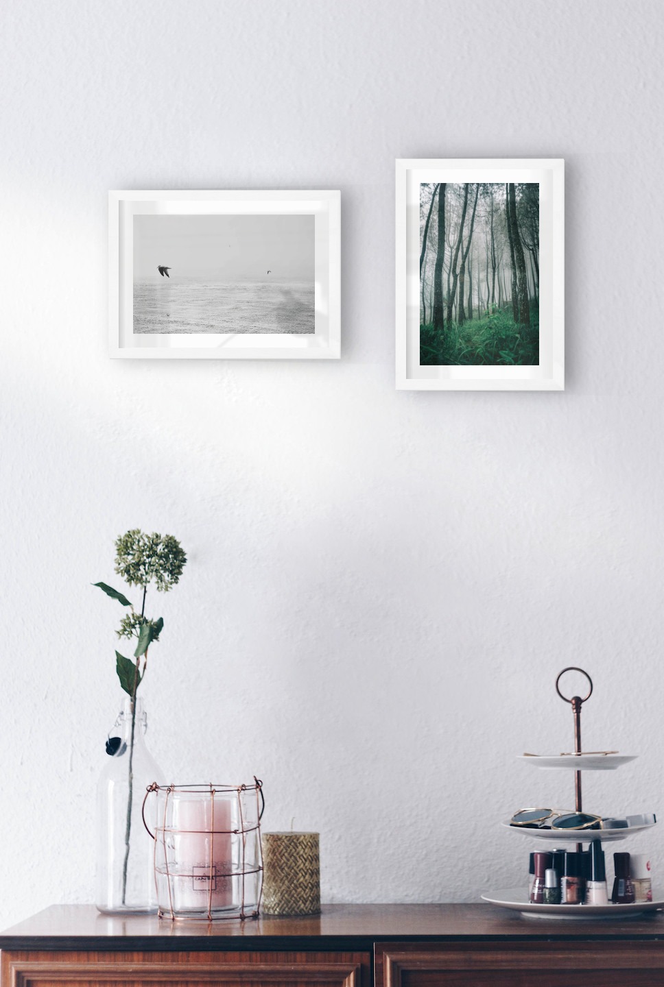 Gallery wall with picture frames in white in sizes 21x30 with prints "Birds over the sea" and "Tall trees"