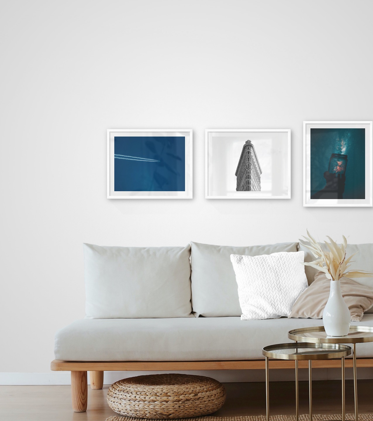 Gallery wall with picture frames in white in sizes 40x50 with prints "Airplanes in the air", "Triangular building" and "Jar in front of space"