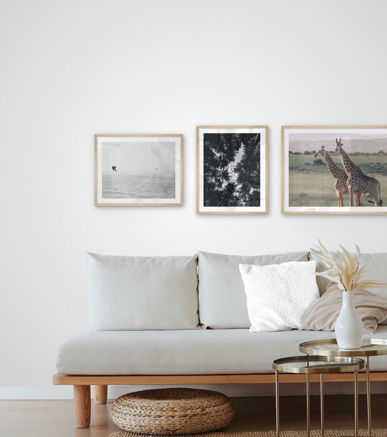 Gallery wall with picture frames in wood in sizes 40x50 and 50x70 with prints "Birds over the sea", "Wooden tops and birds" and "Two giraffes"