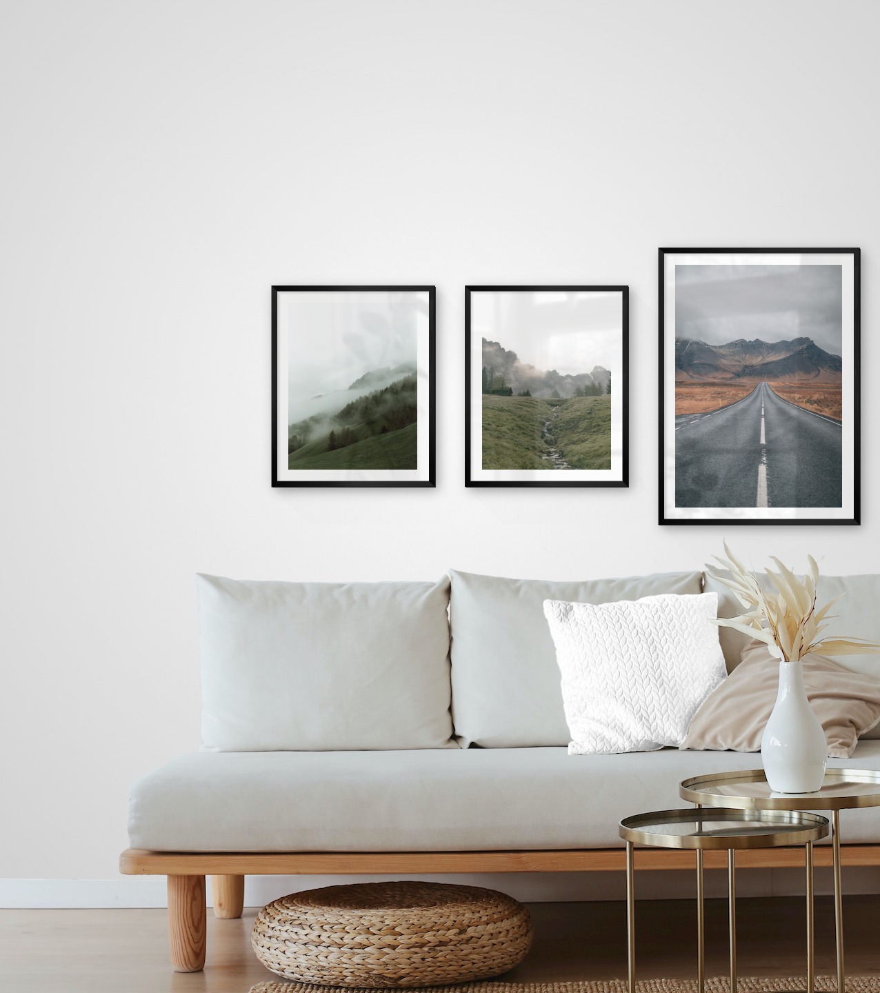 Gallery wall with picture frames in black in sizes 40x50 and 50x70 with prints "Foggy slope", "Green valley in front of mountains" and "Road and mountains"