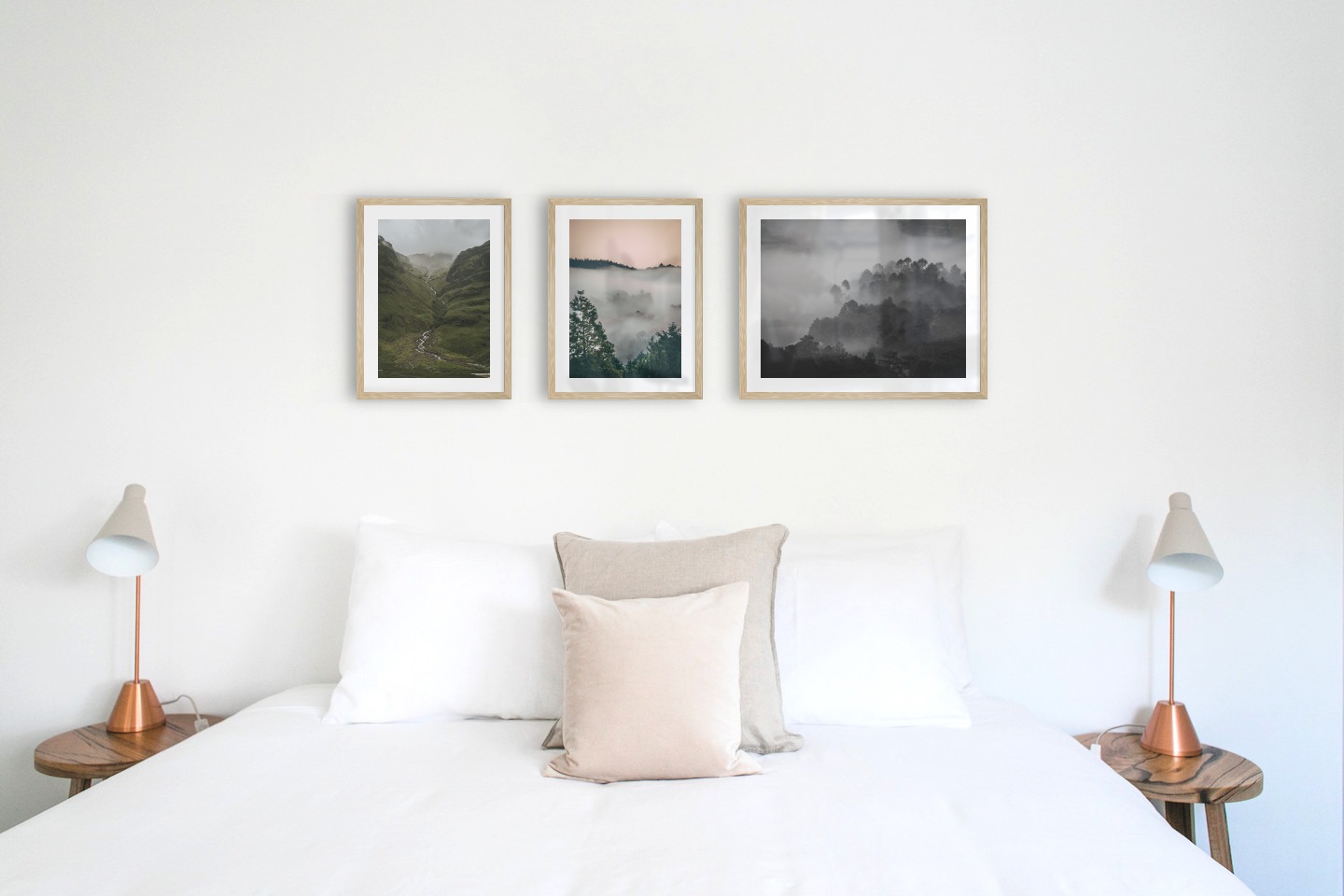 Gallery wall with picture frames in wood in sizes 30x40 and 40x50 with prints "Stream in valley", "Wooden tops and orange sky" and "Foggy wooden tops"