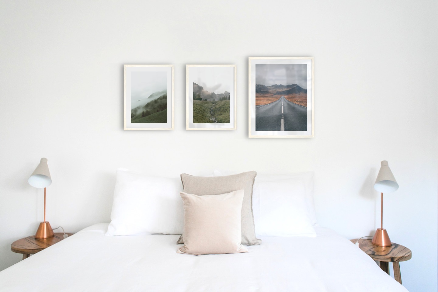 Gallery wall with picture frames in light wood in sizes 30x40 and 40x50 with prints "Foggy slope", "Green valley in front of mountains" and "Road and mountains"